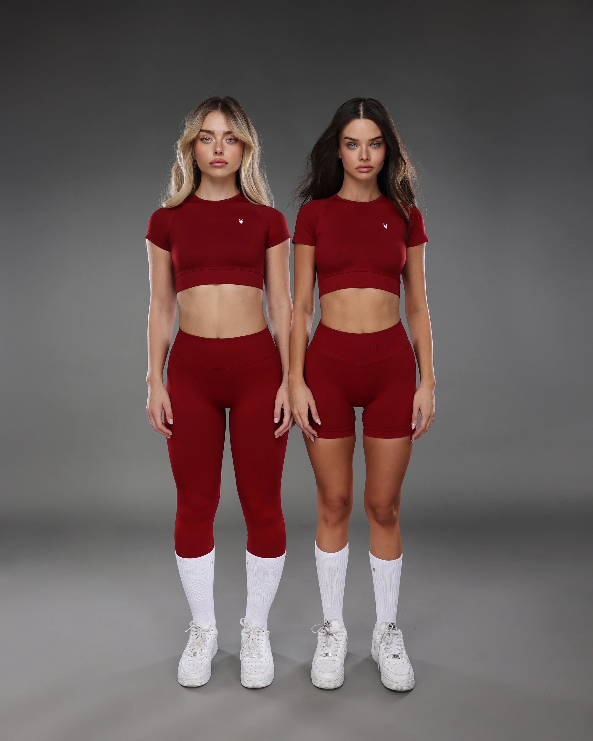 שתי דוגמניות לובשות סט בגדי ספורט יין של אינר דרגון, טייץ ארוך וטייץ קצר, טופ קצר תואם,קולקציית AURA, בגדי ספורט מחטבים ומומלצים לנשים.